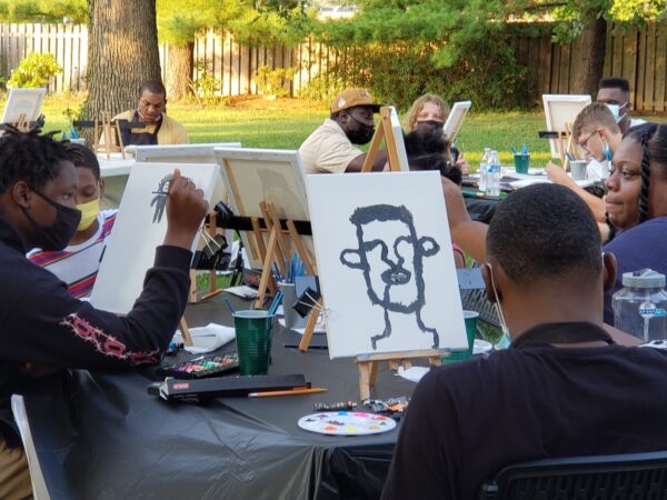 Event attendees painting as a group