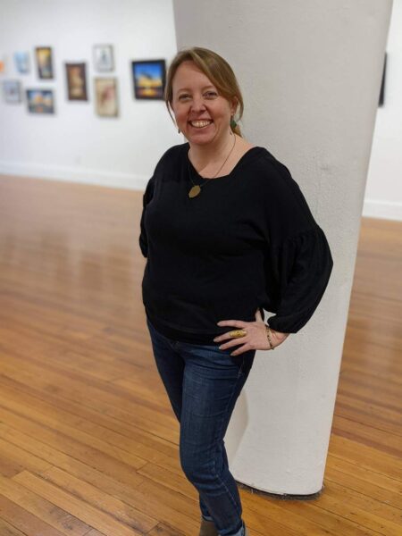 Rachel Lappin standing in gallery space at the Jacoby Arts Center