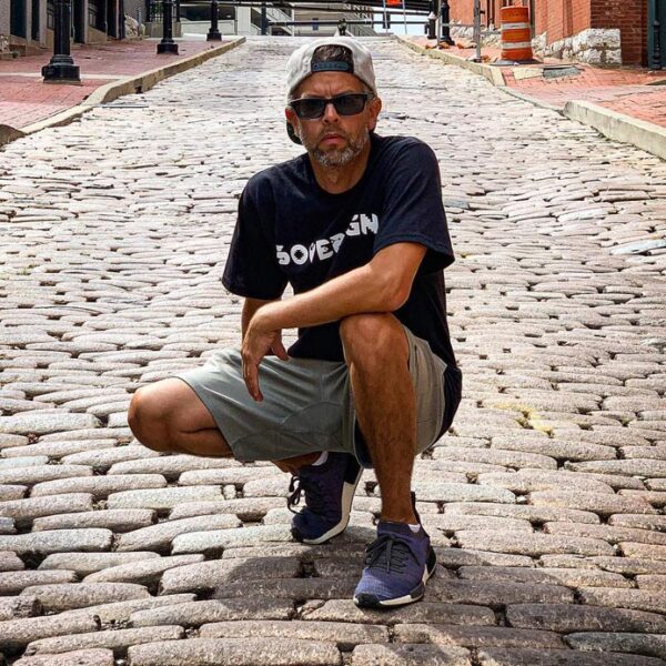 Jason Wesaw posing in the middle of a cobblestone road